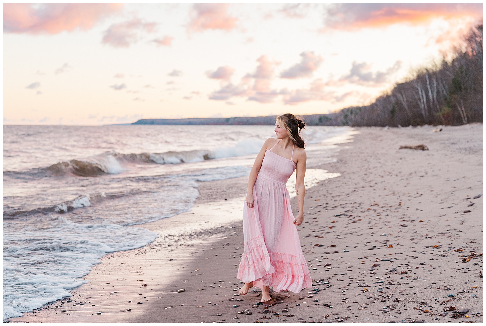 High School Senior walking on beach in Lake Superior