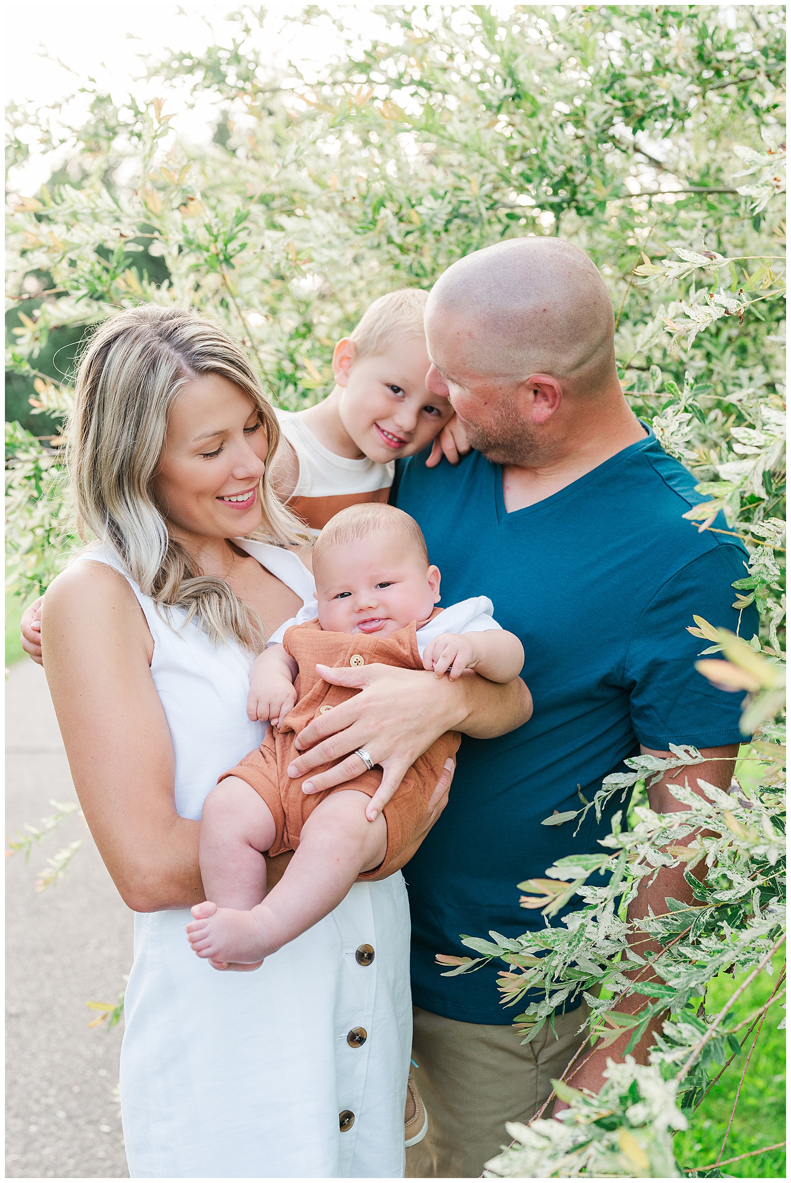 family snuggles with baby in early spring family photo